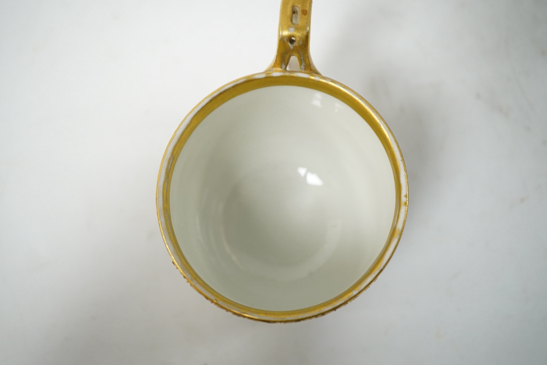 A late 19th century Vienna custard cup and saucer, outside and later decorated, beehive mark, 10cm high. Condition - good